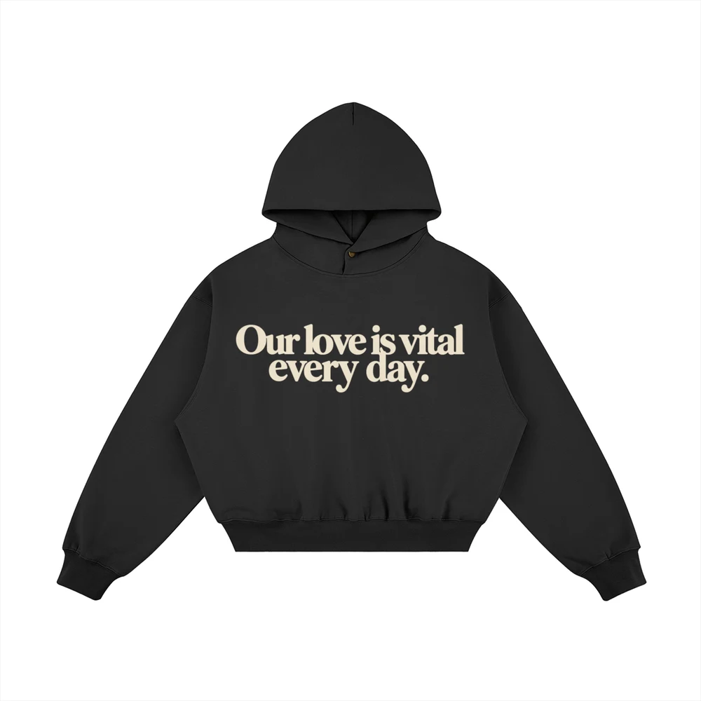 Black hoodie mockup with cream “Our love is vital every day.” lettering on the front.